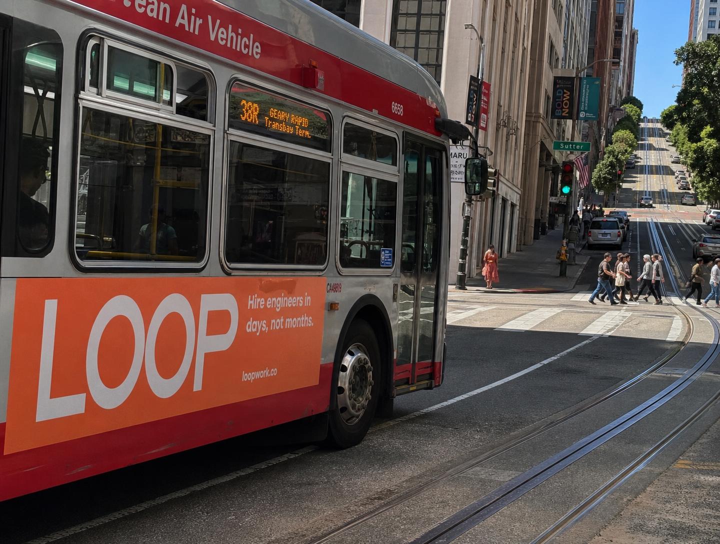 Muni bus wrapped in a startup ad downtown